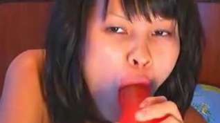 Online film Asian hottie sucking a massive dildo