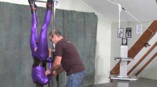 Online film suspended in purple catsuit