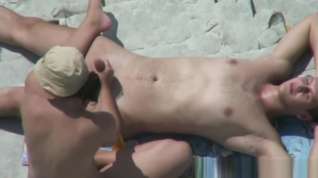 Online film Voyeur 7925-Handjob at nudist rocky beach