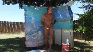 Online film A daddy taking a shower, outdoors, on his patio.