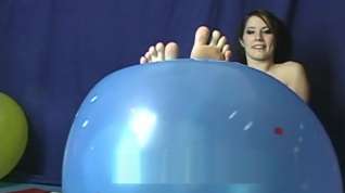 Online film Cute girl pointing her toes and showing her soles playing with balloon