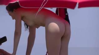 Online film Nudist video at the beach has shy girl playing in the water