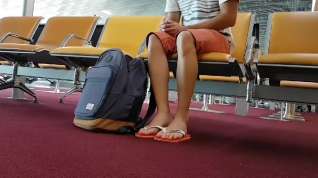 Online film Boy put on flip flops and anklet in airport