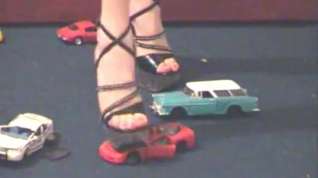 Online film Metal toy cars smashed with stripper heels