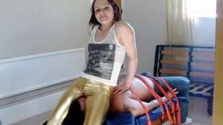 Online film facesitting in gold leggings.