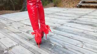Online film Lady L walking with red extreme sexy boots.
