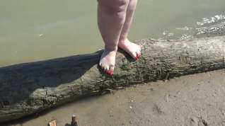 Online film Fat bare legs with red pedicure walk along the bank of the river, fetish.