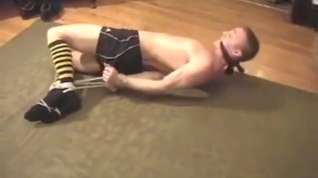 Online film Kent hogtied and cleave gagged in gym shorts struggling and moaning.