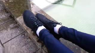 Online film Girl wearing Nike sneakers enters mini-pool