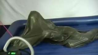 Online film Woman struggling in a green latex bag