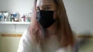 Online film Girl painting her hair in surgical mask and gloves