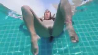 Online film Teen with long hairs swim underwater in pool