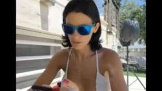 Online film Sandy Yardish having a cigarette outside in swimsuit.