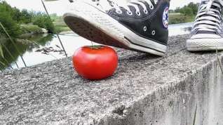 Online film Tomato crushed under All Star Converse sneakers