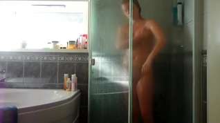 Online film tight, glistening body in the shower