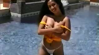 Online film Janice shows her nice little ass as she poses and teases in the pool