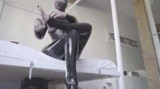 Online film Hooded rubber woman in latex catsuit and ballet boots