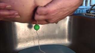 Online film Naughty Gigi plays with her green anal beads