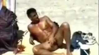 Online film Wanking his huge cock on the beach