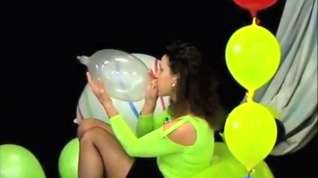 Online film Girl in miniskirt sitting on balloon and inflate long to pop